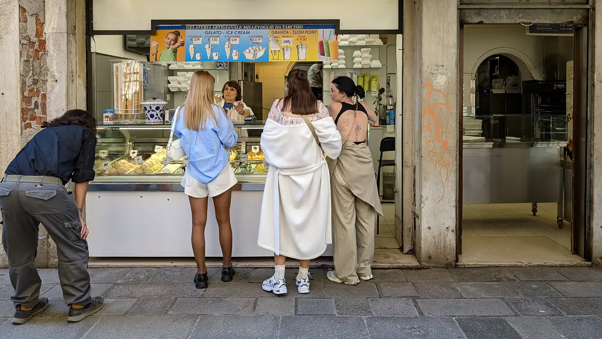 Visitors buy tasty gelato at Millevoglie, a reasonably priced gelateria and pizza take-out shop next to the Frari Church in Vehice.