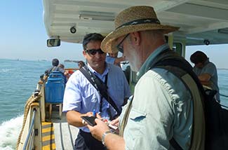 ACTV ticket inspector on vaporetto in Venice, Italy.