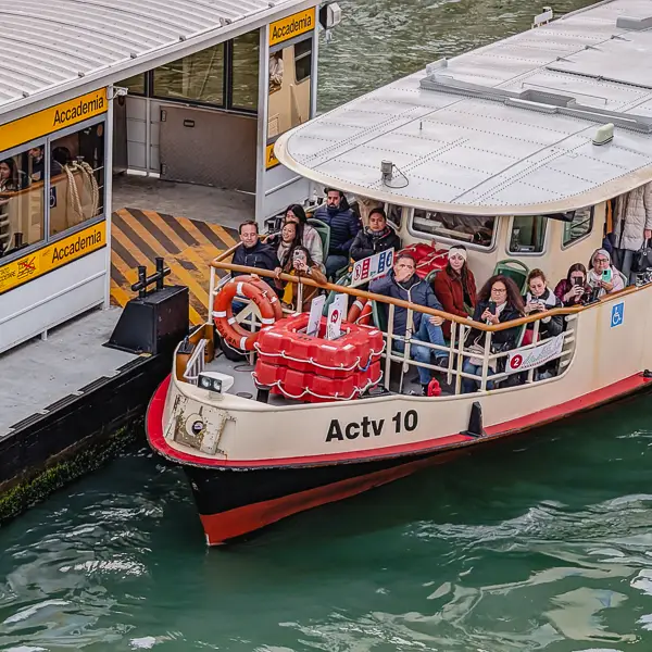 A Line 2 vaporetto departs from the Accademia ACTV stop on Venice's Grand Canal.